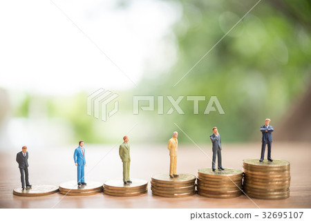 Miniature people standing on stack of coin, Miniature people standing on stack of coin, 32695107