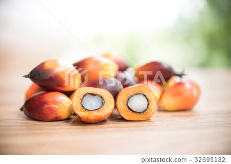A group of oil palm fruits on wood table 32695182