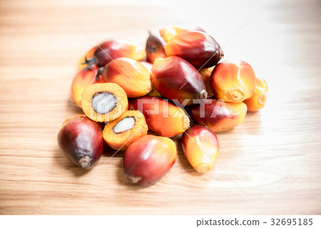 A group of oil palm fruits on wood table 32695185
