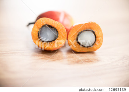 A group of oil palm fruits on wood table 32695189