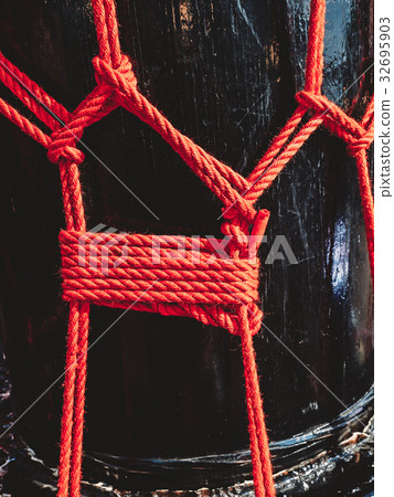 Knots from red ropes taiko drum o-kedo background. 32695903