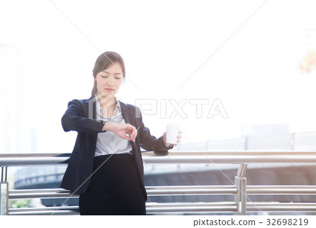 Beautiful business woman holding a cup of coffee  32698219