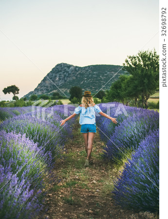 Young blond woman traveller walking in lavender Young blond woman traveller walking in lavender 32698792