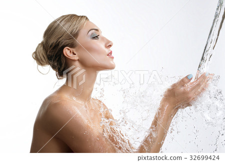Young happy girl catching water stream in hands Young happy girl catching water stream in hands 32699424