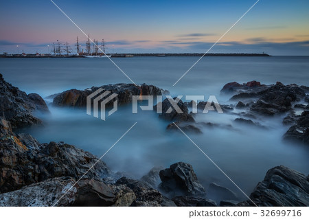 Beautiful sunset over sea. Sailboat in the bay. Beautiful sunset over sea. Sailboat in the bay. 32699716