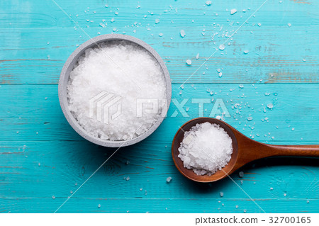 sea salt in bowl and in spoon on wooden background 32700165