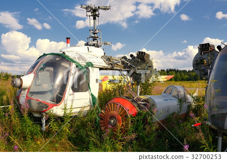 Old airplane fuselage and rusty helicopters 32700253