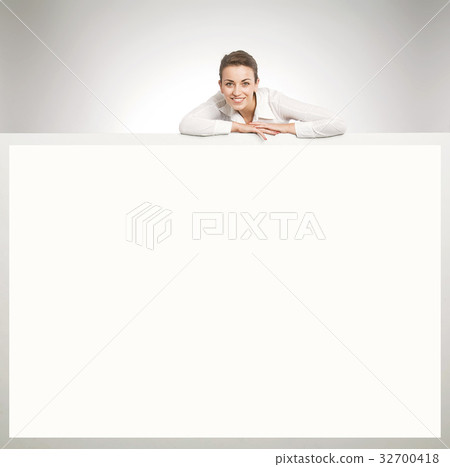 Pretty businesswoman leaning on the giant board Pretty businesswoman leaning on the giant board 32700418