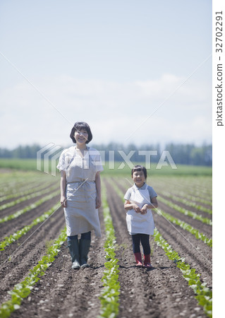 Parent and child walking in the field 32702291