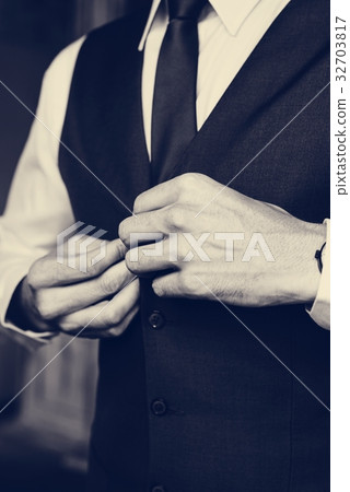 Handsome Groom Dressing Up for Wedding Ceremony Handsome Groom Dressing Up for Wedding Ceremony 32703817