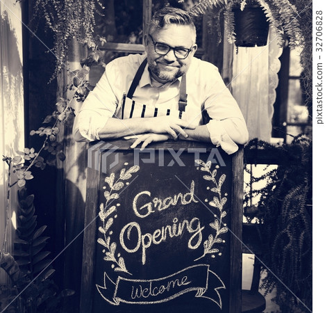 Adult Man Standing with Grand Opening Sign 32706828