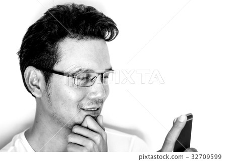 Man using smartphone with smile and happy Man using smartphone with smile and happy 32709599