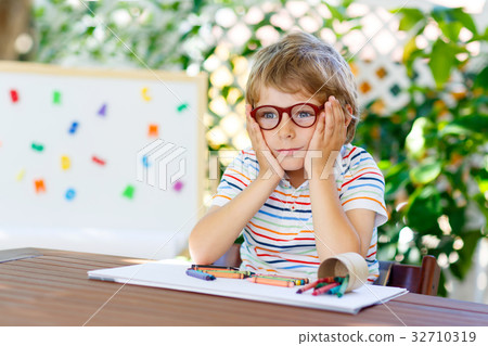 Little kid boy with glasses holding school 32710319