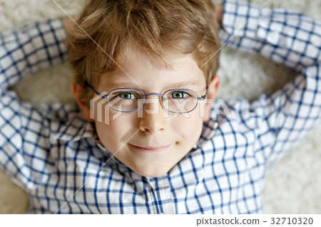 Close-up portrait of little blond kid boy with 32710320