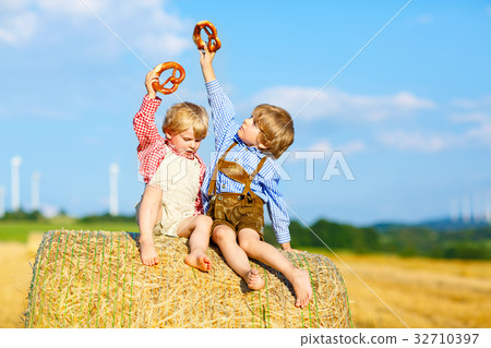 Two little kid boys, twins and siblings sitting on Two little kid boys, twins and siblings sitting on 32710397