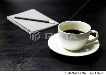 Coffee with notebook and pencil on wood background Coffee with notebook and pencil on wood background 32711671