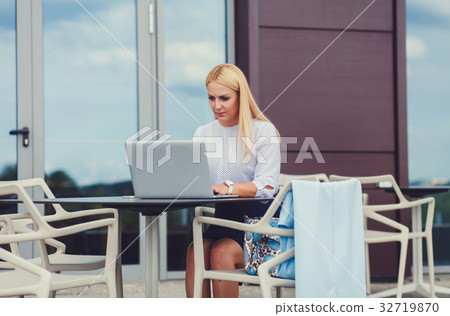 woman using notebook in cafe woman using notebook in cafe 32719870