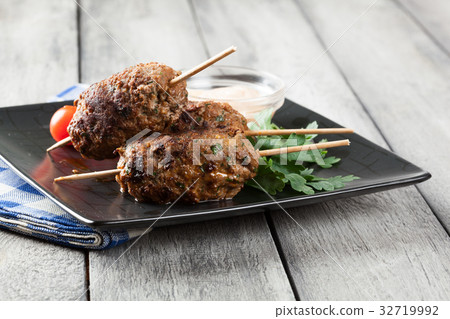 Barbecued kofta with vegetables on a plate 32719992