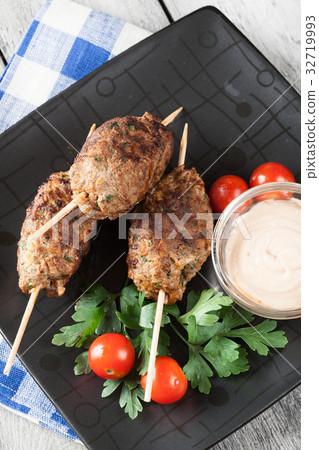 Barbecued kofta with vegetables on a plate 32719993