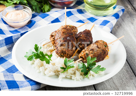 Barbecued kofta with rice on a plate 32719996