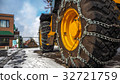 Tractor tires with chains in the snow. 32721759