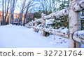 Wooden fence with heavy snow. 32721764