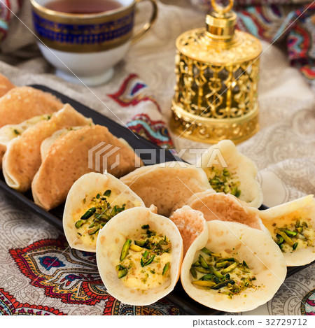 Arabic kataif pancakes with cream and pistachio Arabic kataif pancakes with cream and pistachio 32729712