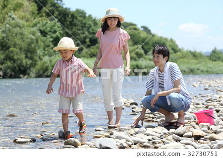 Young family playing in the river Young family playing in the river 32730751