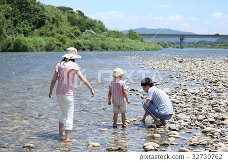 Young family playing in the river Young family playing in the river 32730762
