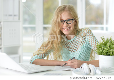 cute teen girl doing homework 32733276