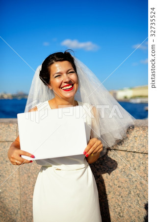 Portrait of a bride with plate on quay Neva river, Saint-Petersburg 32735524