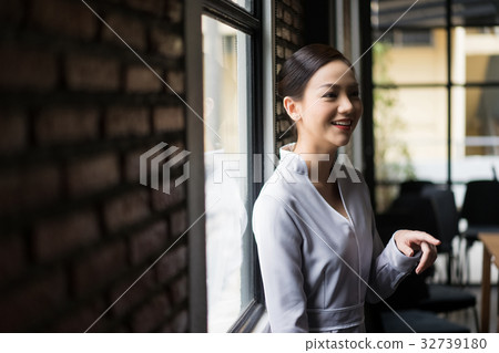 A woman is talking with someone and smiling 32739180