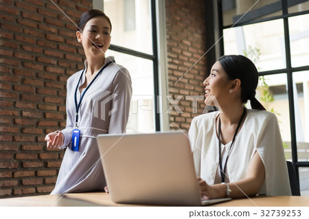 two business women are talking each other in the office two business women are talking each other in the office 32739253