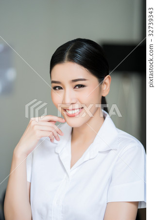 a portrait of beautiful woman looking at camera and smiling a portrait of beautiful woman looking at camera and smiling 32739343