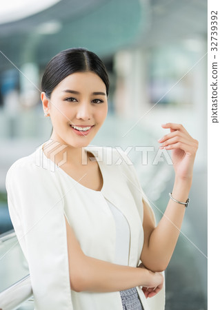The portrait of beautiful girl standing and smiling The portrait of beautiful girl standing and smiling 32739392