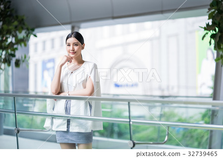 a woman is standing inside the building and thinking 32739465