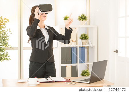 mixed race asian chinese worker excited using a VR mixed race asian chinese worker excited using a VR 32744472