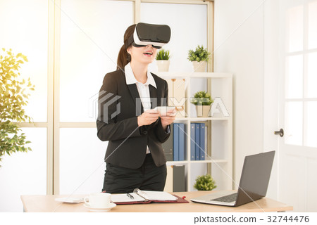 woman playing video games virtual reality glasses woman playing video games virtual reality glasses 32744476