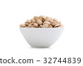 Pistachios in a white ceramics bowl 32744839