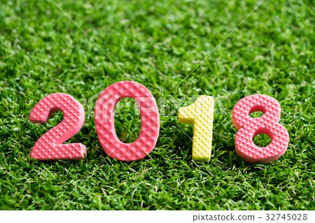 Toy alphabet in wording 2018 on green grass  32745028