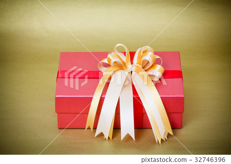 red gift box with gold ribbon on yellow background red gift box with gold ribbon on yellow background 32746396