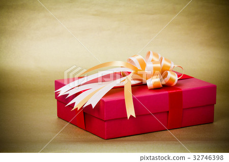 red gift box with gold ribbon on yellow background red gift box with gold ribbon on yellow background 32746398