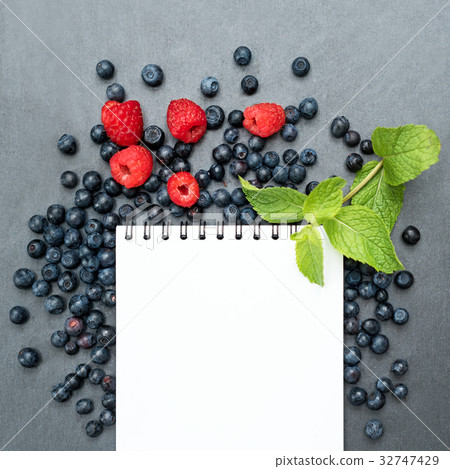 Blueberries, raspberries, mint and notepad for Blueberries, raspberries, mint and notepad for 32747429