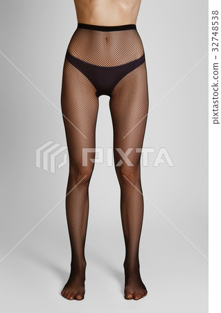 Long slim female legs in elegant fishnet tights 32748538