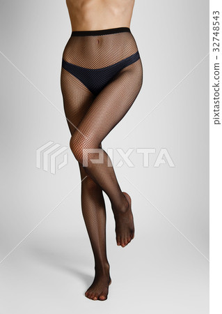 Long slim female legs in elegant fishnet tights 32748543