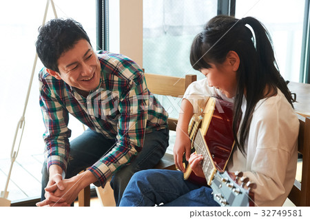 Parents playing the guitar 32749581