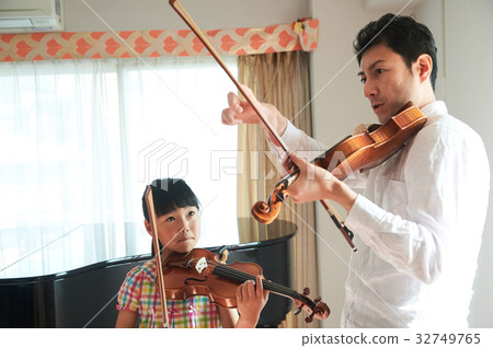 Girl taking a violin lesson 32749765