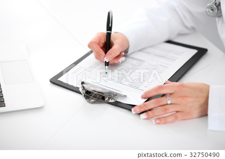Close-up of a female doctor filling ou Close-up of a female doctor filling ou 32750490