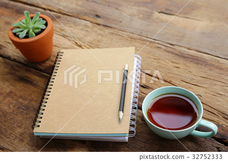 Red tea and notebook with plant Red tea and notebook with plant 32752333
