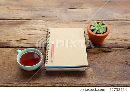 Red tea and notebook with plant Red tea and notebook with plant 32752334